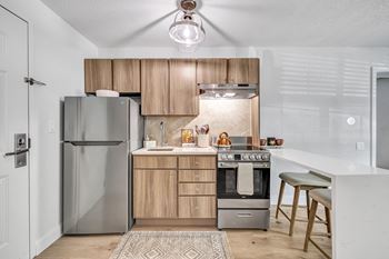 A kitchen with stainless steel appliances and wooden cabinets